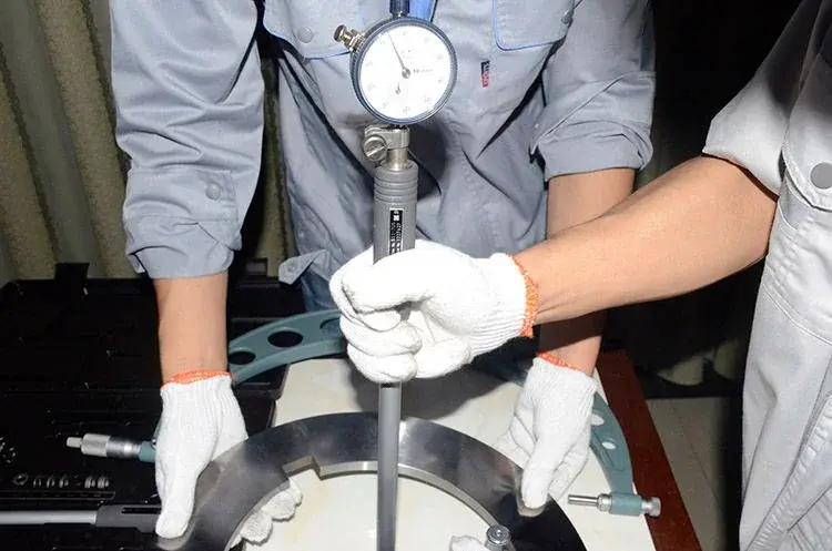 Inspector using a dial bore measuring instrument inside a circular tool