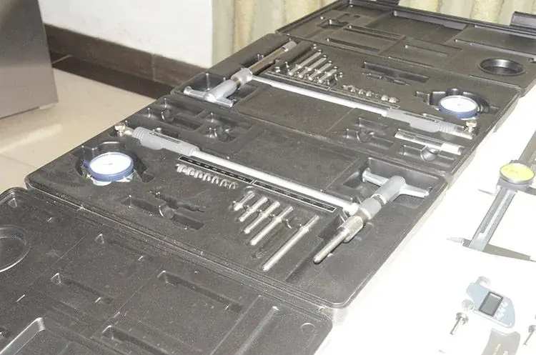 Measuring instruments arranged in fitted cases on an inspection bench