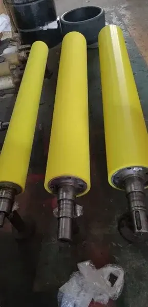 Yellow-covered pinch rolls with exposed metal shafts