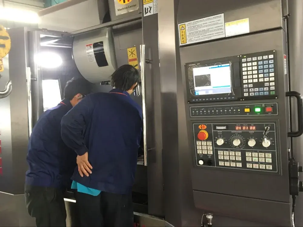 Operators working at a machining center in the workshop